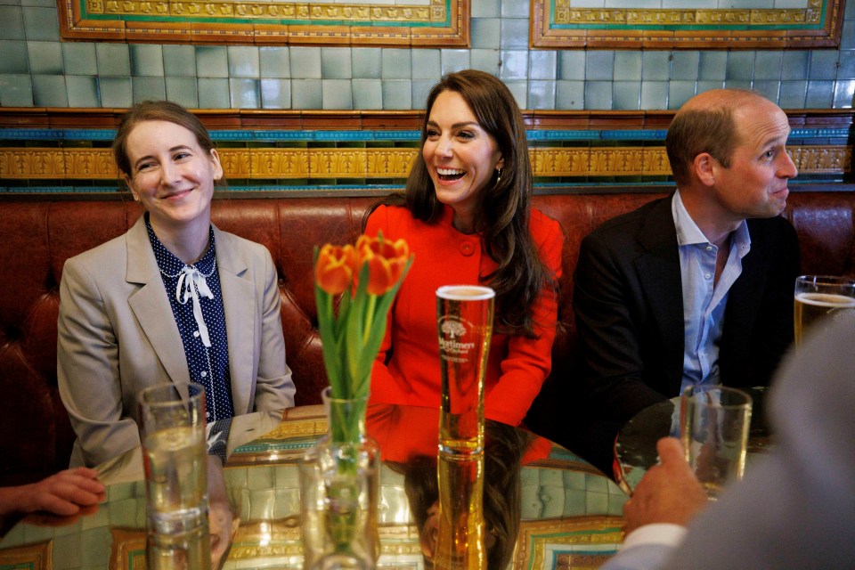 Kate laughed as she sat beside her husband in the cozy booth