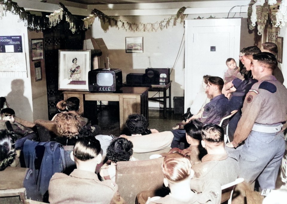 Berlin: British troops tuned in with a photograph of Her Majesty beside their TV