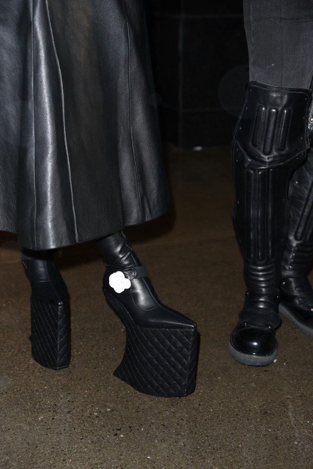 Cardi wore a full-length coat and ridiculously towering Chanel platform boots