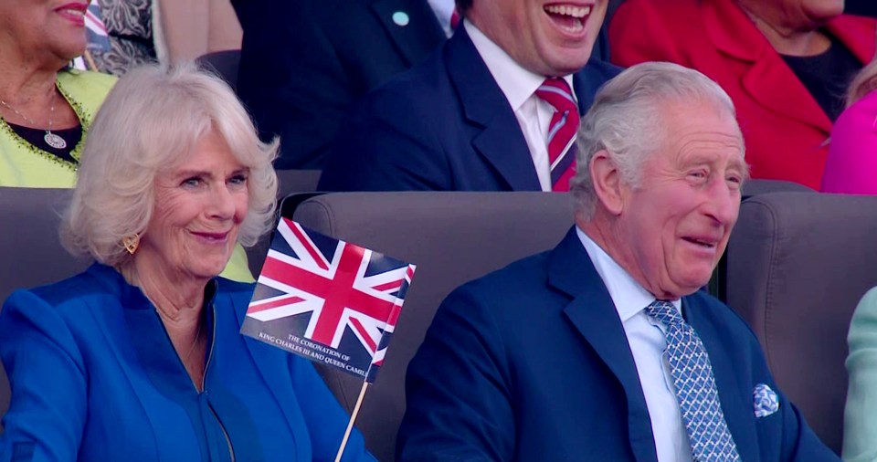 The new King was all smiles as Camilla waved her flag