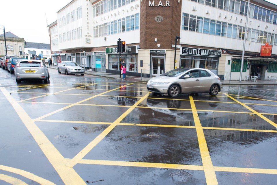 EGJPKB Cars in a yellow box junction in Cardiff, UK. Cameras have been installed around the city to fine drivers stopping illegally.