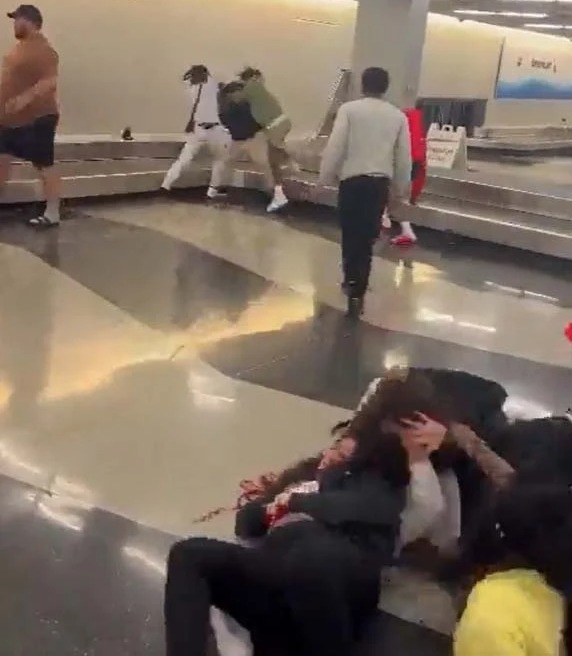 A group of men began battering each other on the luggage belt