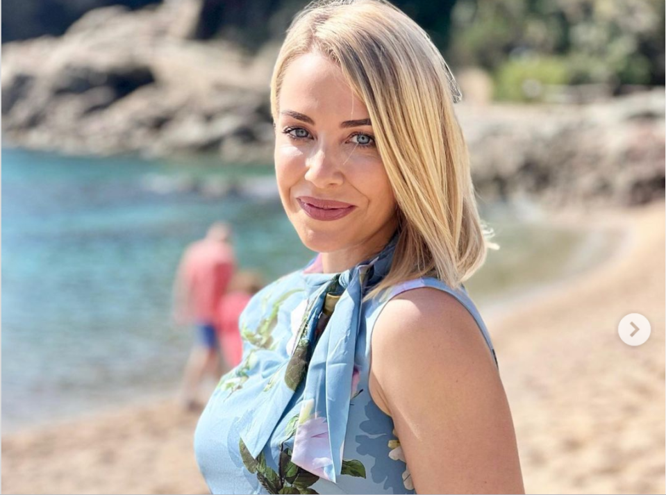 The star left fans swooning as she posed in a blue floral dress while on the sunny beach in Barcelona