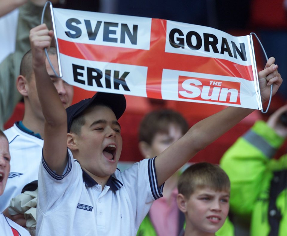 a boy holds up a banner that says sven goran erik