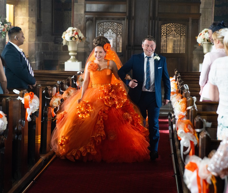 Her character will say I Do to Chesney Brown in a flowing orange dress with LED detail