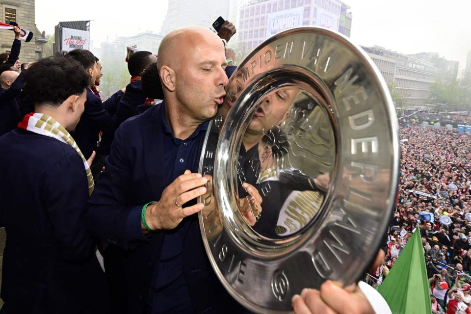 Slot, 44, celebrates with the Eredivisie trophy