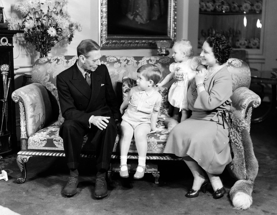 Charles with grandad George VI on a sofa for a photo session