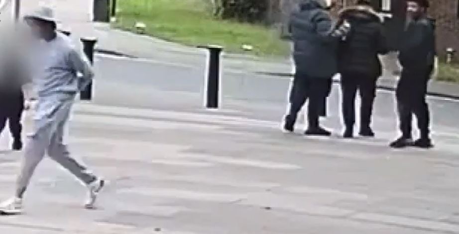 The man is spotted by the gunman walking in the group who then runs after him