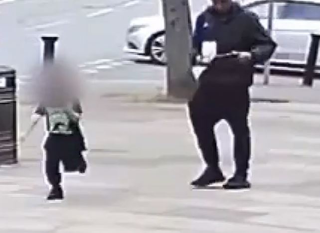 The child runs for their life as the gunman pulls the weapon out a bag