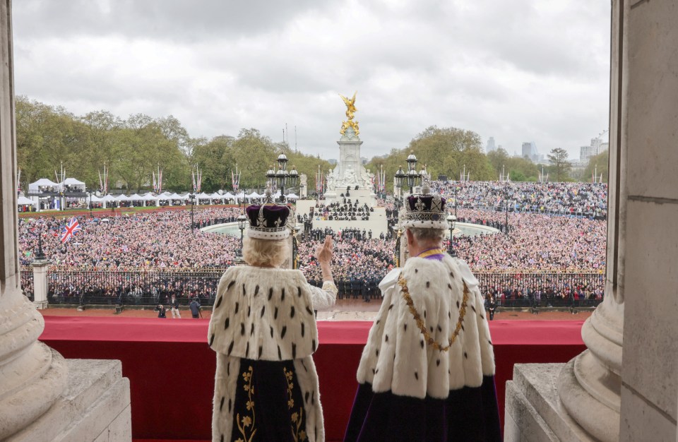 King Charles III and Queen Camilla look out onto thousands of royal fans