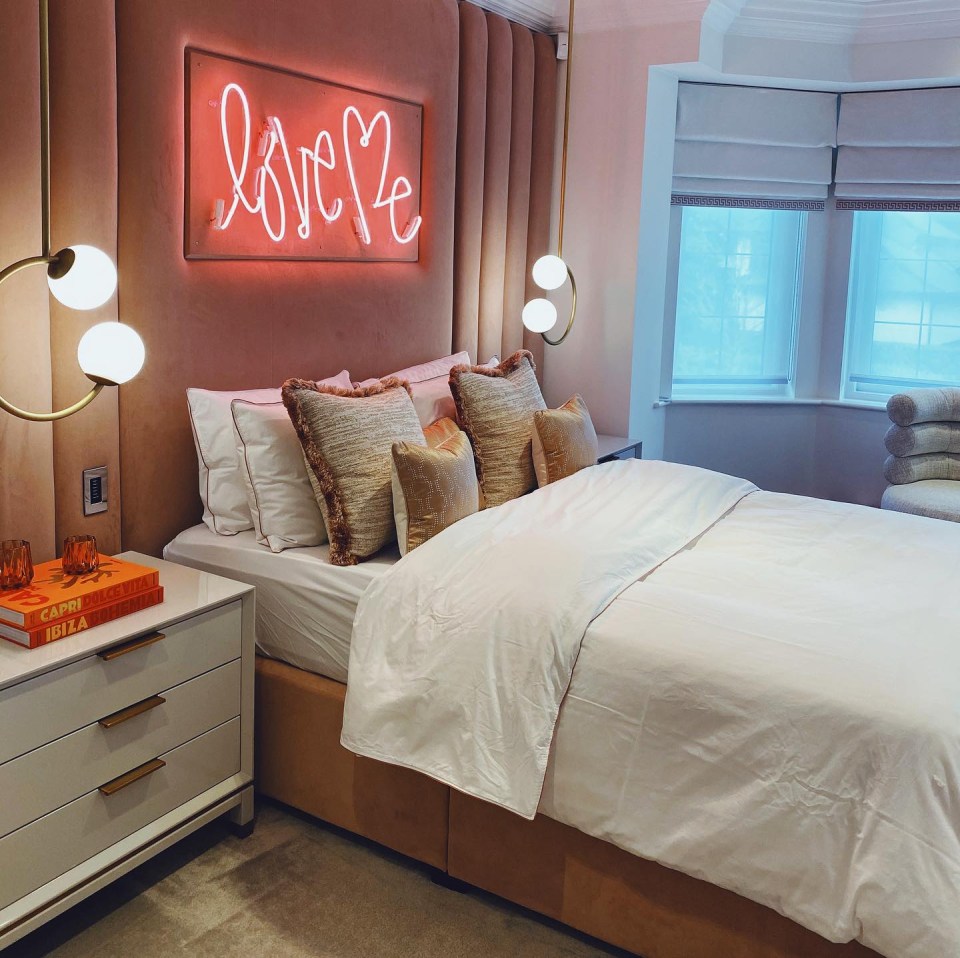 Sheree has a chic bedroom with a neon sign above the bed