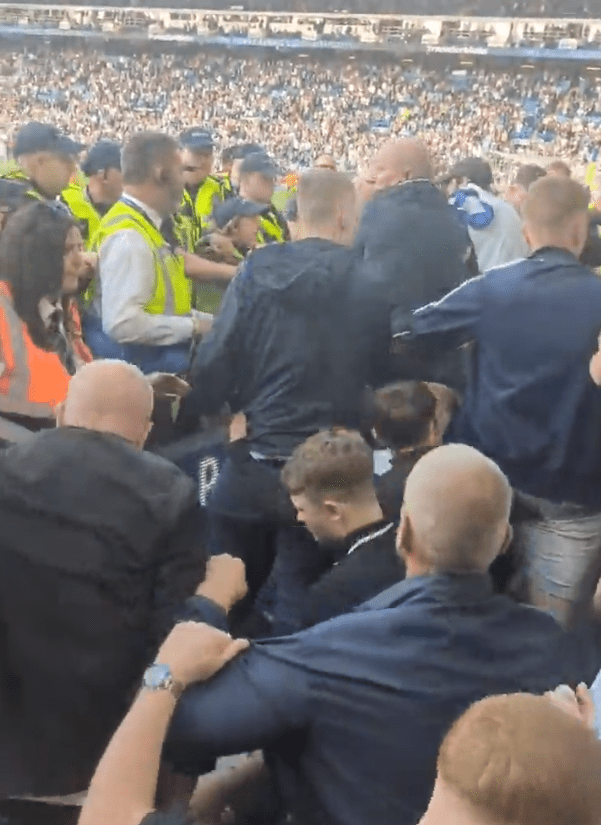 Ugly scenes explode as Leeds United fans clash with police following their relegation from the Premier League