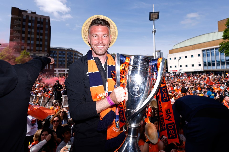 Luton Town manager Rob Edwards celebrates the club's promotion in the city centre