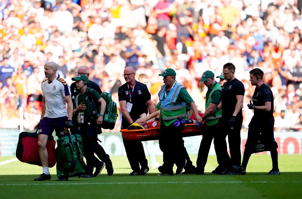 He was stretchered after being helped by both clubs’ medical teams