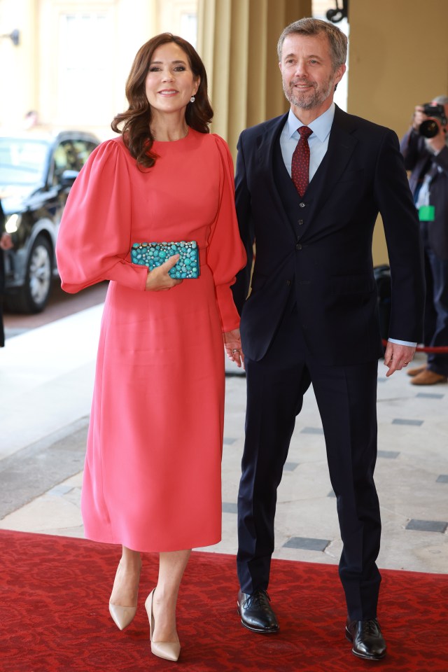 Denmark’s Crown Prince Frederik, 54, was also snapped with wife Princess Mary, 51, who was wearing a coral-pink Andrew Gn dress