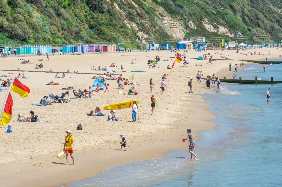 People enjoy a day out at the beach as temperatures remain higher than average for May in Bournemouth, Dorset