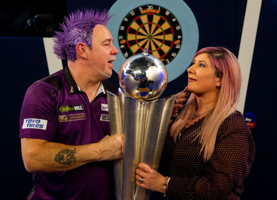 Peter Wright celebrates winning with his wife Jo in 2020