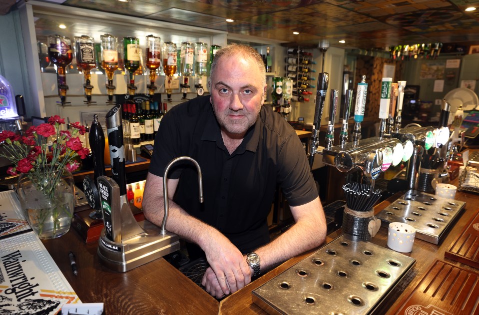 Duncan Harper behind the bar at The Crown pub