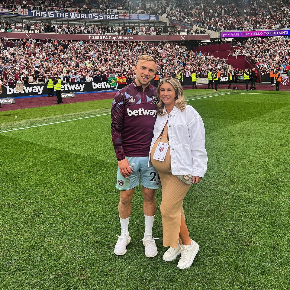 Pregnant Dani with Jarrod on the pitch at West Ham's grounds