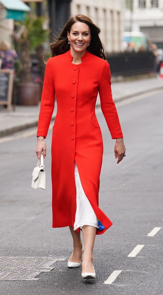 The Princess of Wales arrived for their visit smiling, dressed in a vibrant red coat