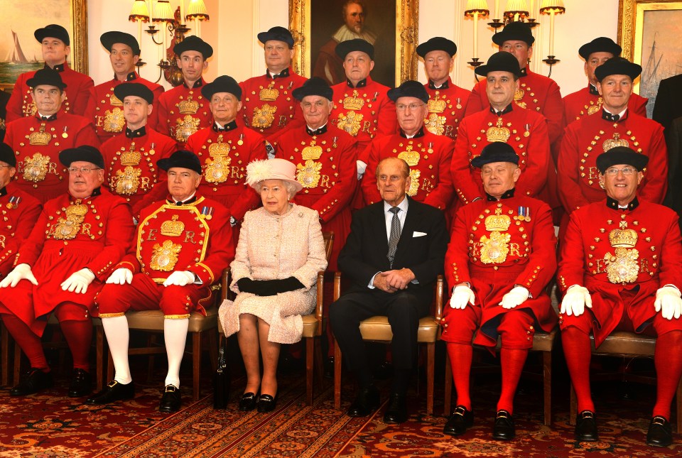 Queen Elizabeth II and Prince Phillip, Duke of Edinburgh sit for a photo with Watermen and Lightermen of the River Thames