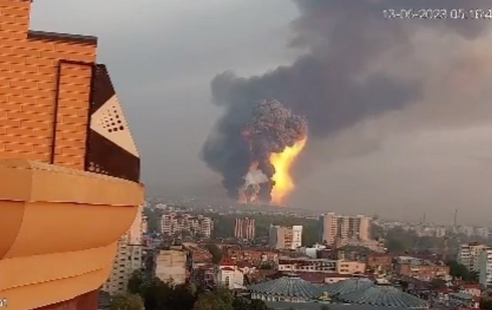 Thick, black smoke is seen billowing into the air