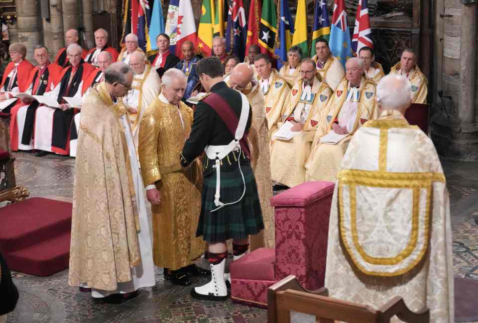 The Coronation Girdle — made of cloth of gold — is used to attach the Jewelled Sword of Offering