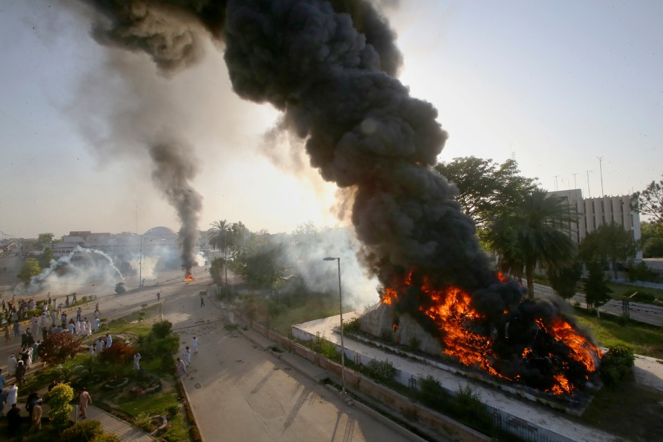 Smoke erupts after protesters set a fire in Pweshawar