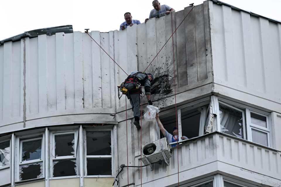 A specialist inspects damage to a building from the drone attacks in Moscow