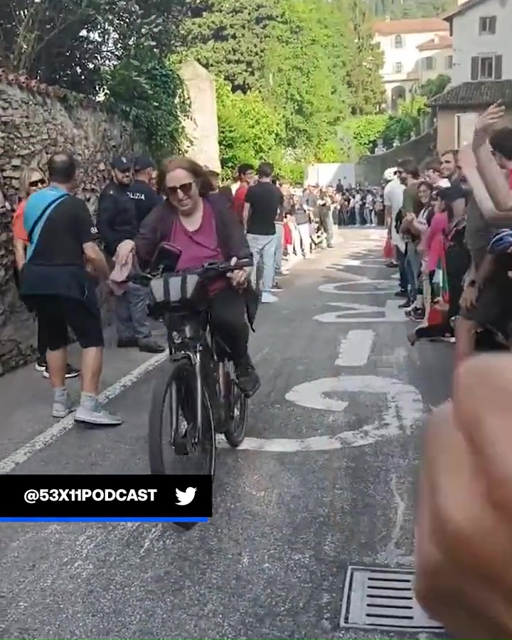 The cyclist can be seen with a huge grin on her face as she makes her way through