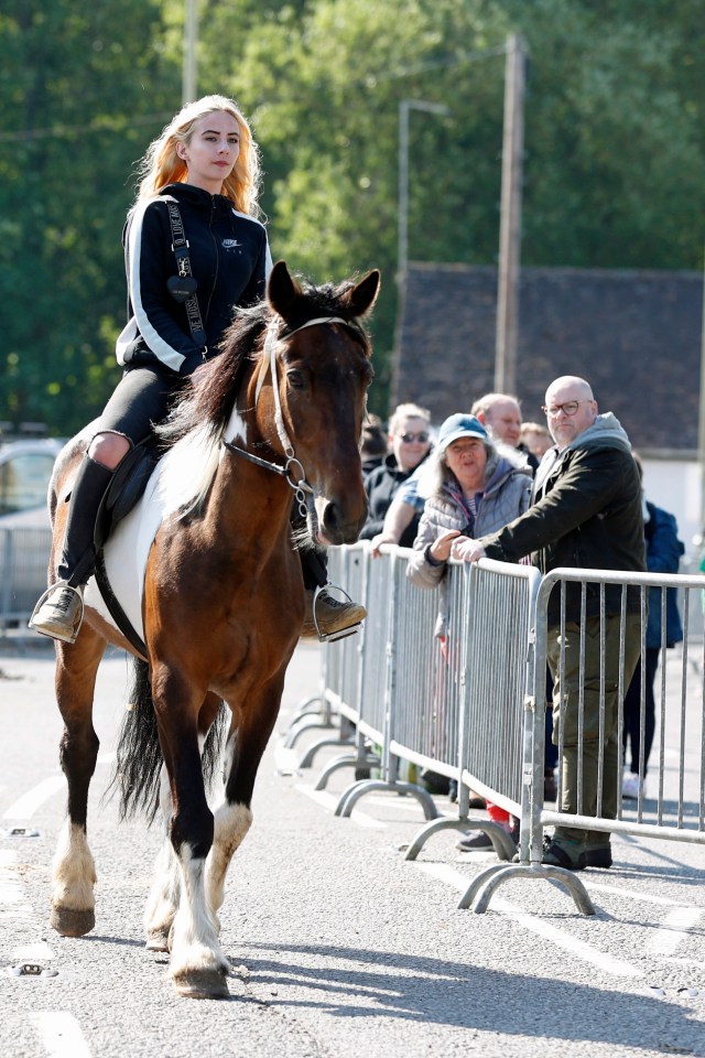 A rider makes her way through the centre of the village