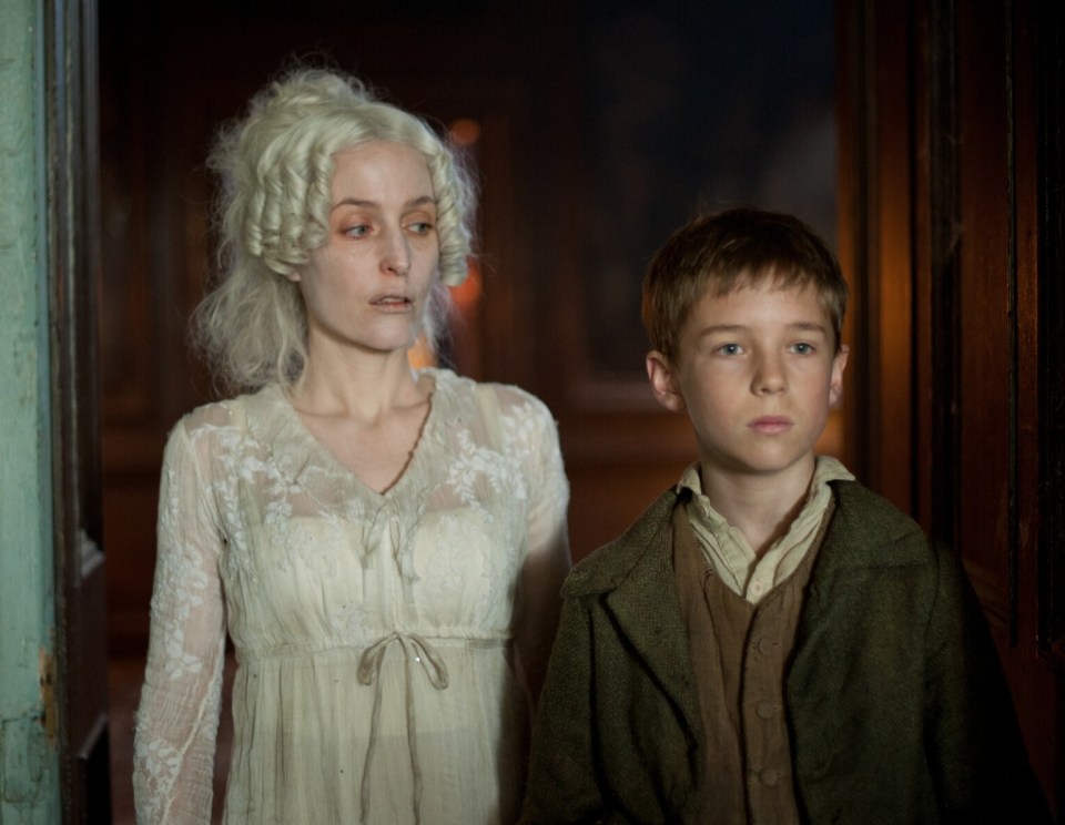 Miss Havisham played by Gillian Anderson and a young Pip played by Oscar Kennedy in a 2011 adaptation