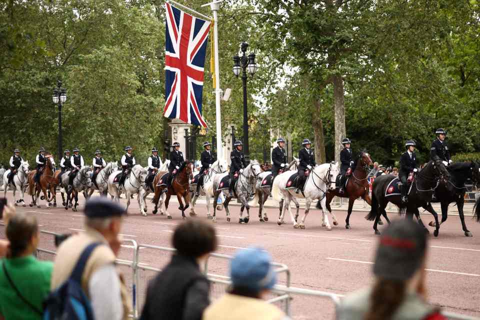 Police officers riding horses patrol along The Mall as they arrive prior to the King’s Birthday Parade