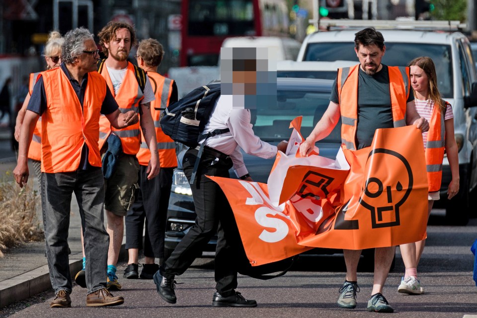 A lad in school uniform blasts an eco mob in London yesterday