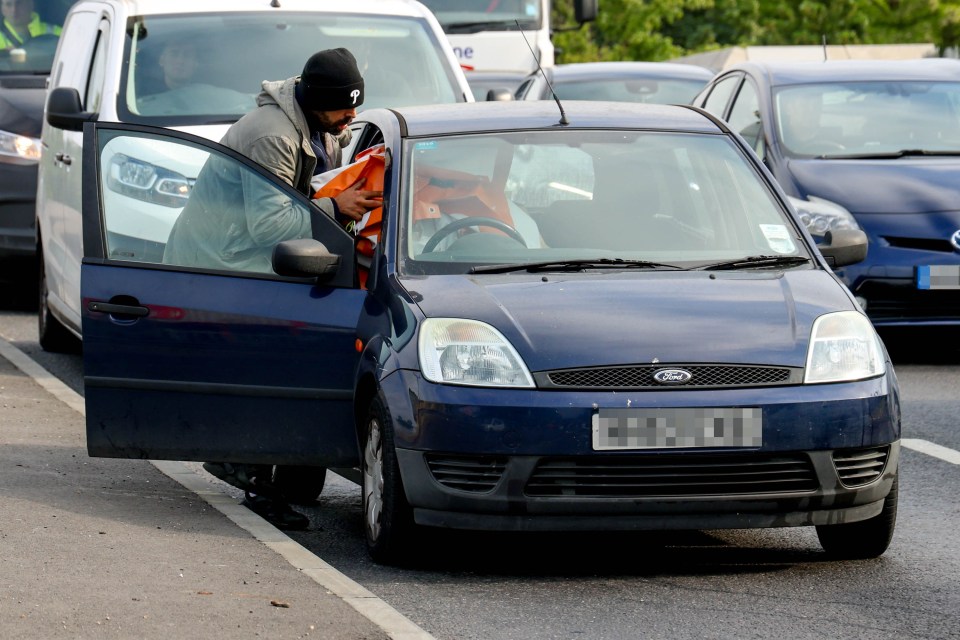 A fed up motorist bundled a Just Stop Oil banner into his car after seizing it