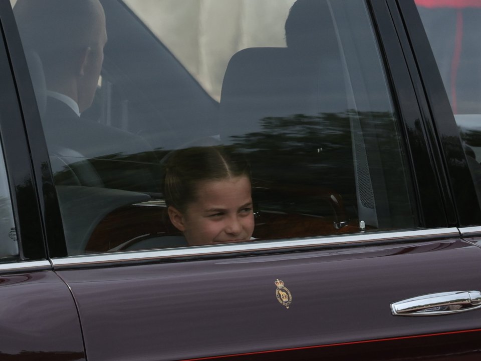 Cheeky Charlotte and Louis smiled at fans lined up along The Mall