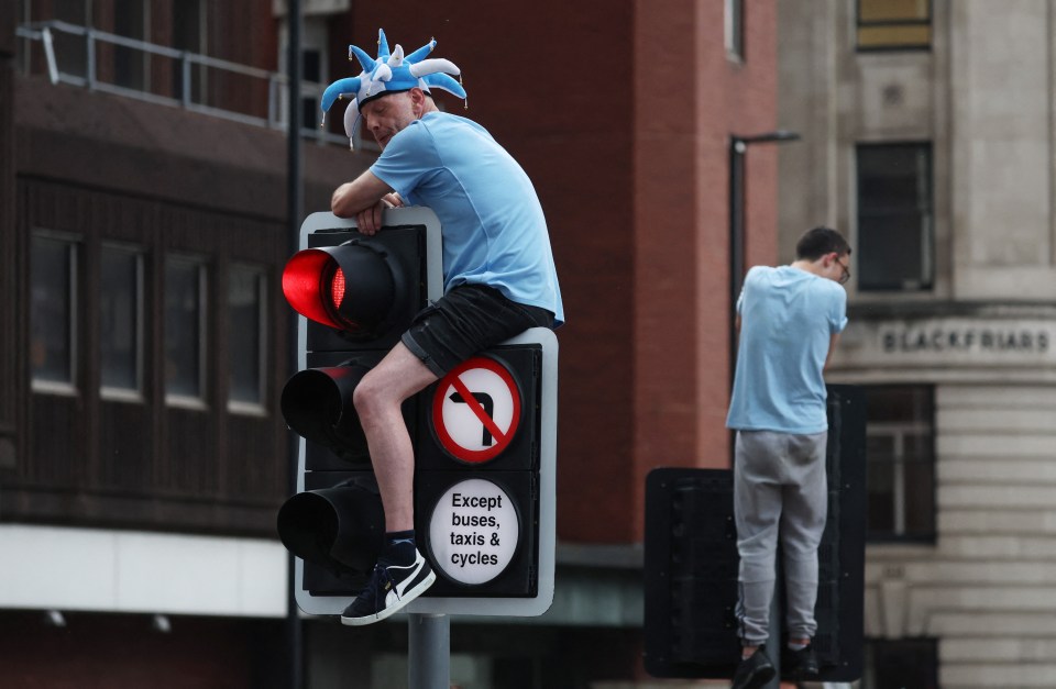 Supporters hung from traffic lights to get the perfect view