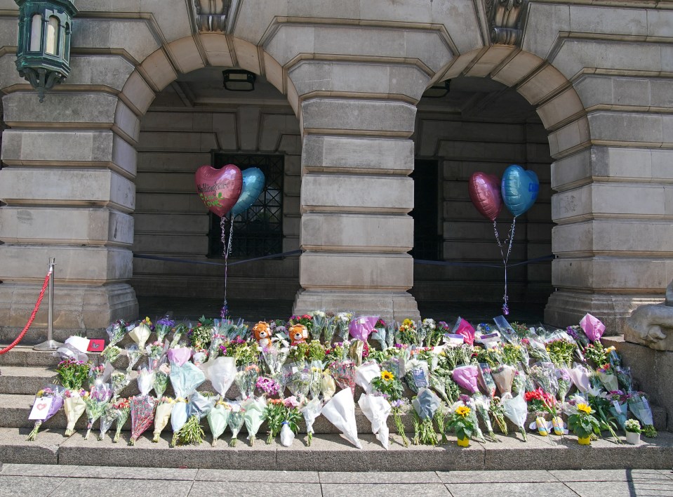 Hundreds of flowers have been left scattered across the city for the victims