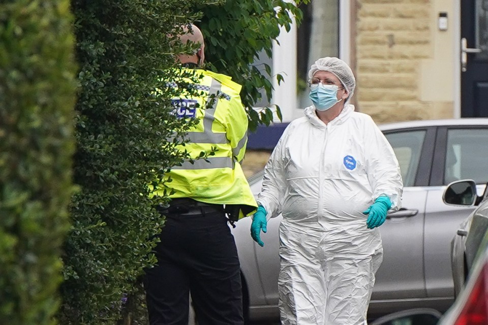 Forensic officers scoured the property for clues