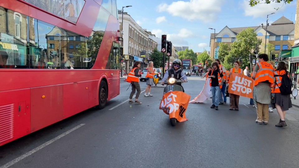 The moment the moped rider smashes through the banner