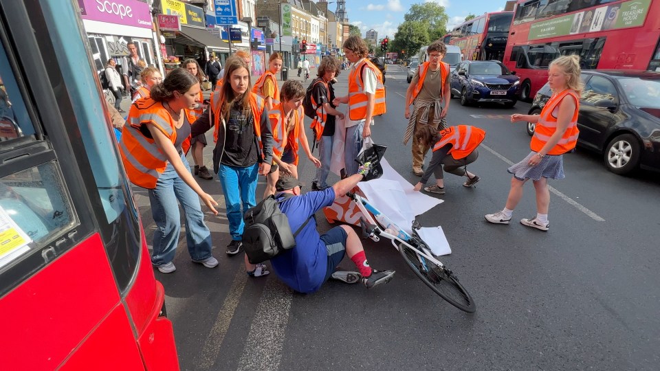 A cyclist fell off his bike after becoming entangled in the protest