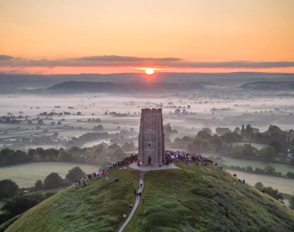 Dozens of people gather at Glastonbury Tor, Somerset, on Wednesday