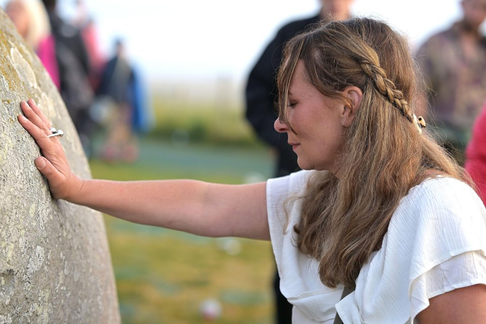 A visitor connects with a rock