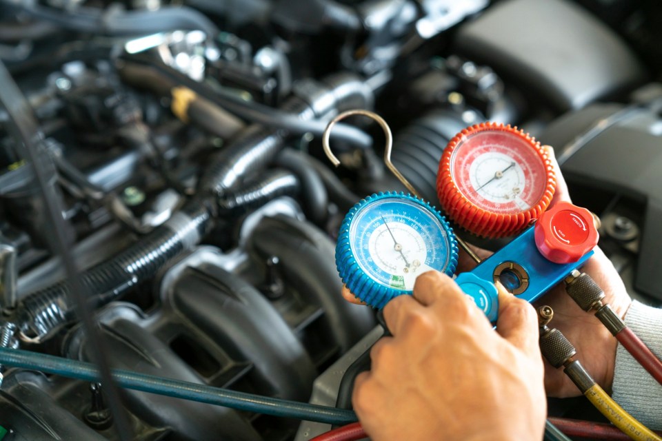 monitor tool on car engine ready to check and fixed car air conditioner system in car garage