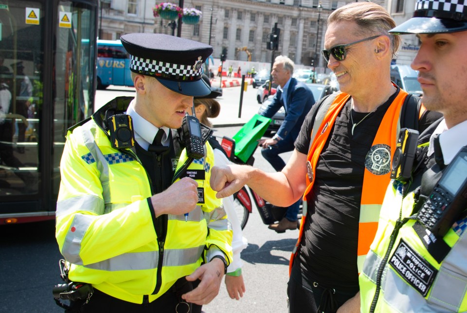 Energy tycoon Dale Vince was seen fist-bumping a police officer on a Just Stop Oil march