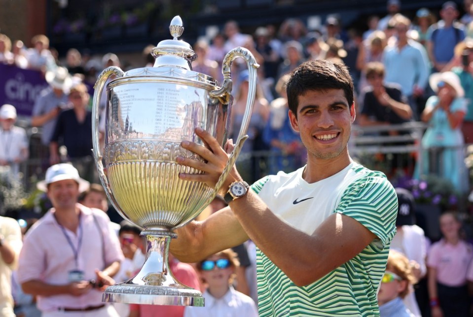 LONDON, ENGLAND - JUNE 25: Carlos Alcaraz of Spain celebrates with the winner's trophy after victory against Alex De Minaur of Australia in the Men's Singles Final match on Day Seven of the cinch Championships at The Queen's Club on June 25, 2023 in London, England. (Photo by Julian Finney/Getty Images)