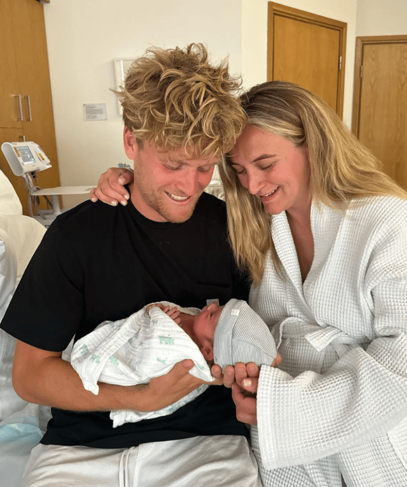 Cameron Geehan cradles their son Jude as Tiffany Watson looks emotional