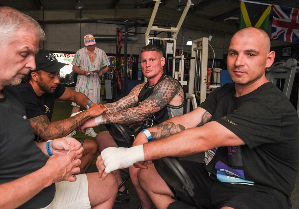 Daz Clarke and Liam Gell have there hands wrapped before the fight