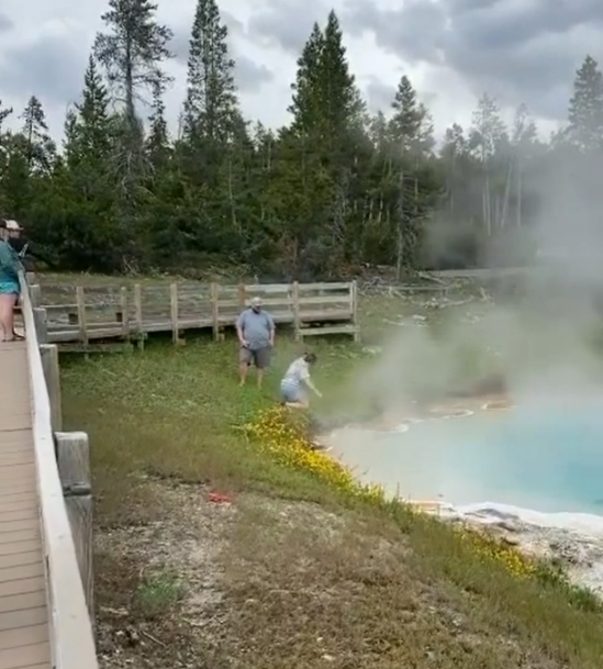 The father and daughter approach the steaming hot spring after being warned not to