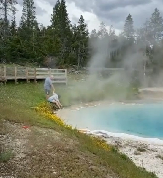 He helps his daughter to lean close to the boiling water